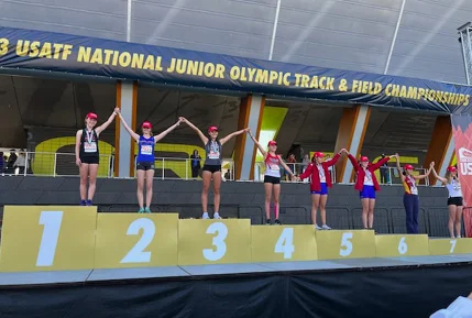 Star Students on the Junior Olympics Track and Field Winner's Podium
