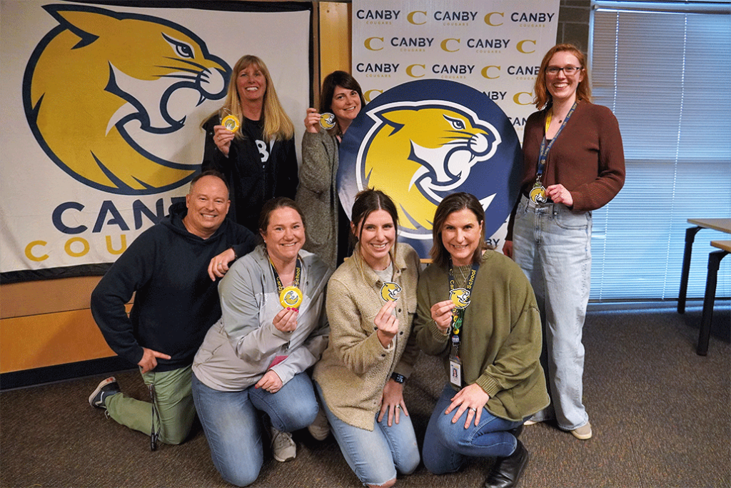 Students and staff pose with the new Canby Cougar logo