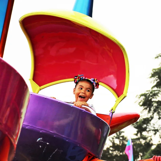 A child enjoys a whirling carnival ride