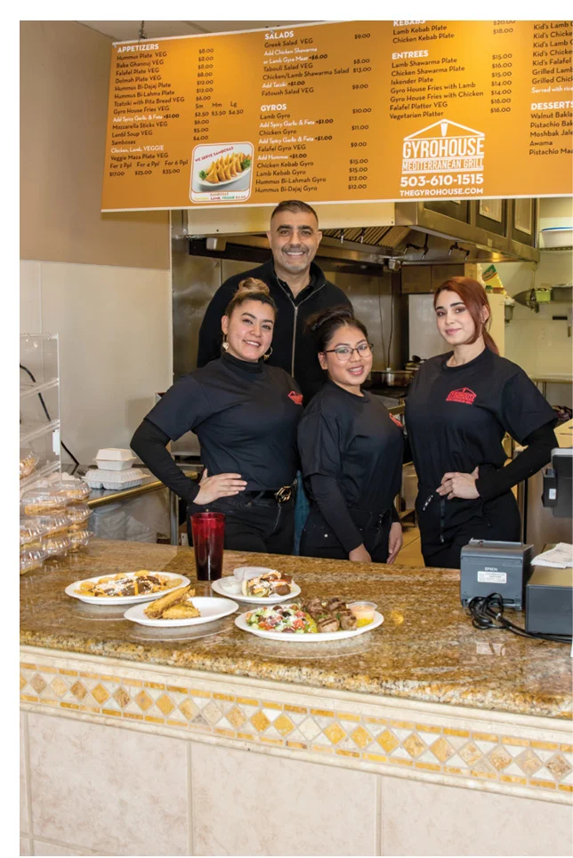 The owners of Gyro House proudly show a sample of their food.