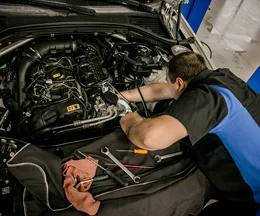 A Mechanic works on an engine