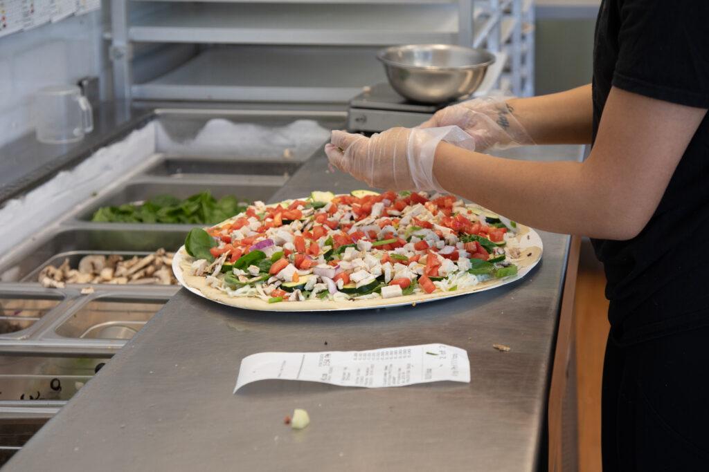 Fresh Pizza Being Made at Pap Murphy's