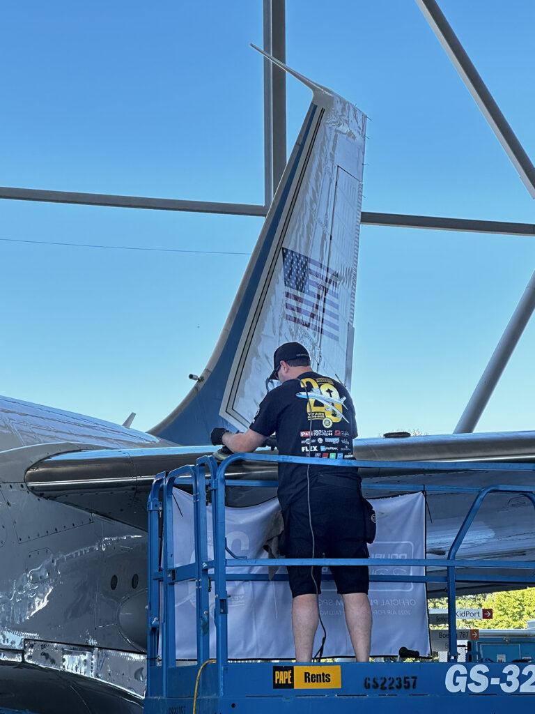 A technician Working on detailing a plane