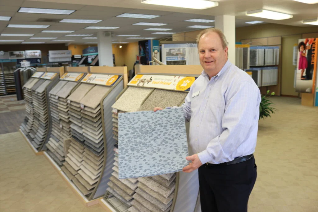 Mac McLarens holds a carpet sample