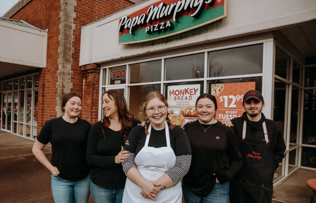 The owner ad staff stand in front of Papa Murphy's
