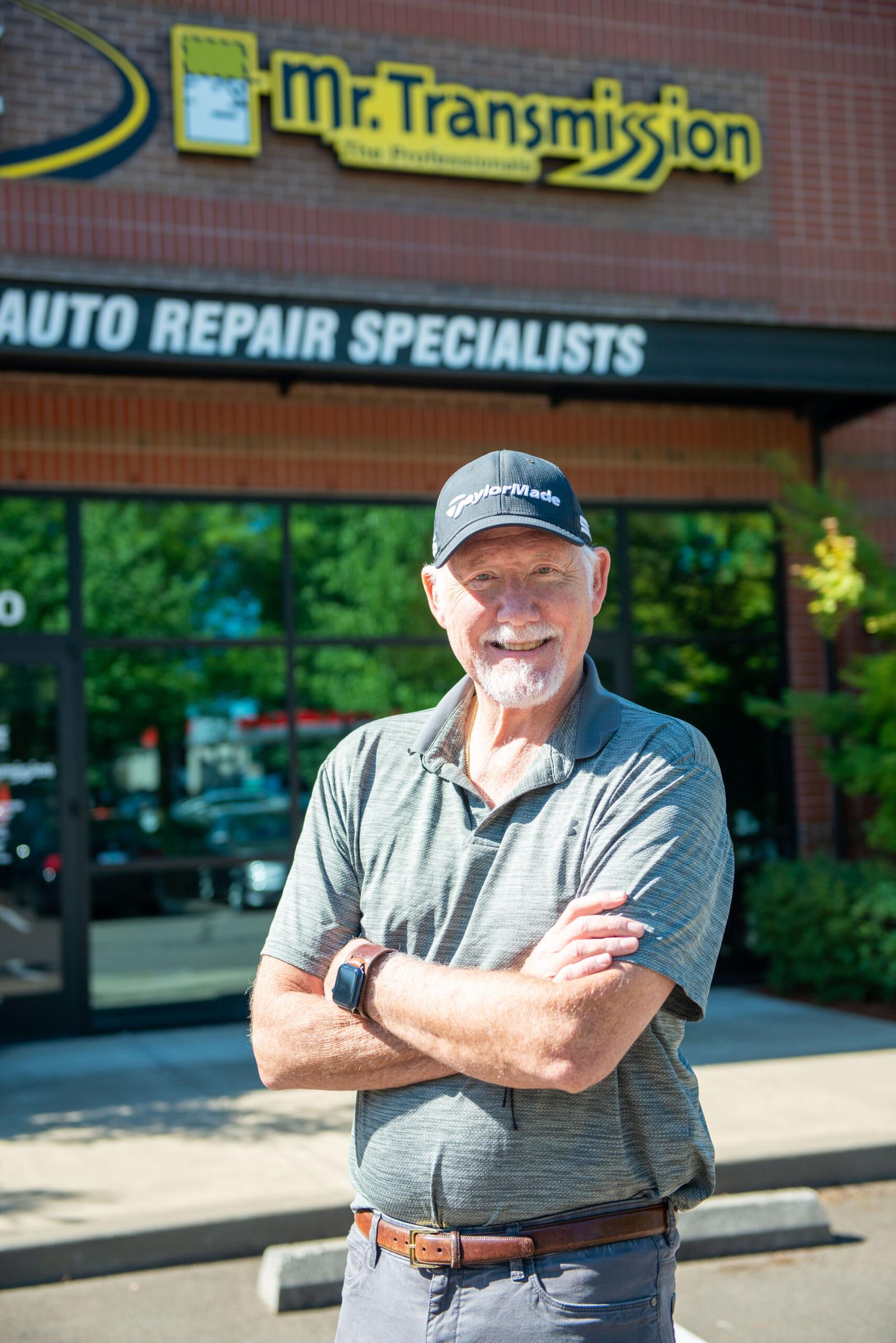 The owner of Mr Transmission stands in front of his building