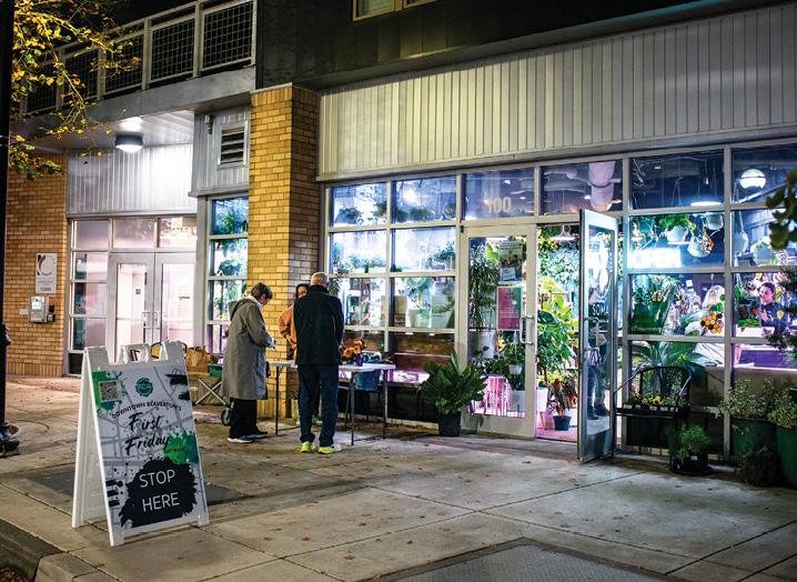 People stand outside an inviting shoppe