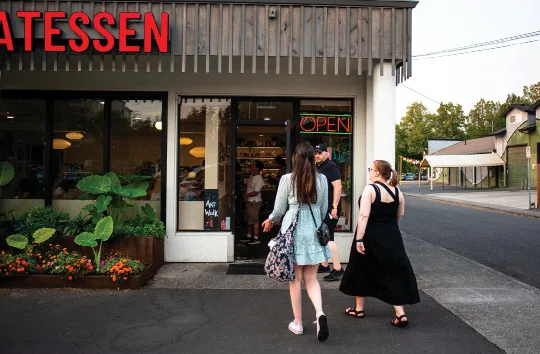 A group of people going into a local shoppe