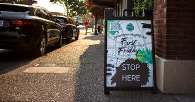 Sandwich board sign that says, First Friday, Stop Here